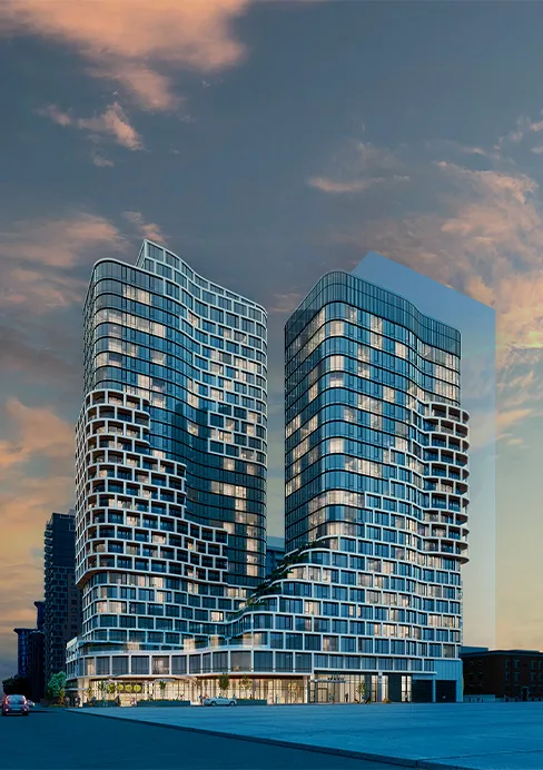 Two tall buildings of the Relevé building, adorned with windows on the sides, exemplifying modern urban architecture.